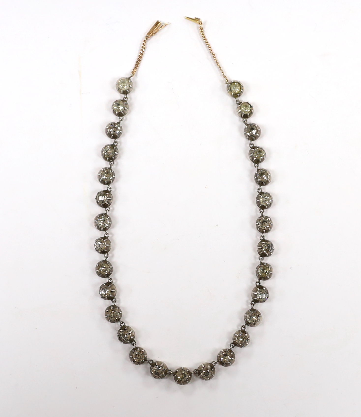 An early 19th century yellow and white metal, foil backed paste set necklace, with later 585 clasp, 32cm.